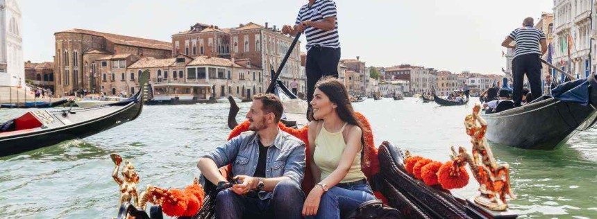 A couple enjoying a gondola ride in Venice grand canal