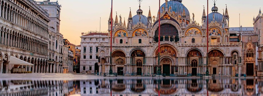 Sunrise in San Marco square with Campanile and San Marco's Basilica. The main square of the old town. Venice, Veneto Italy. Reflection on the flooded square.